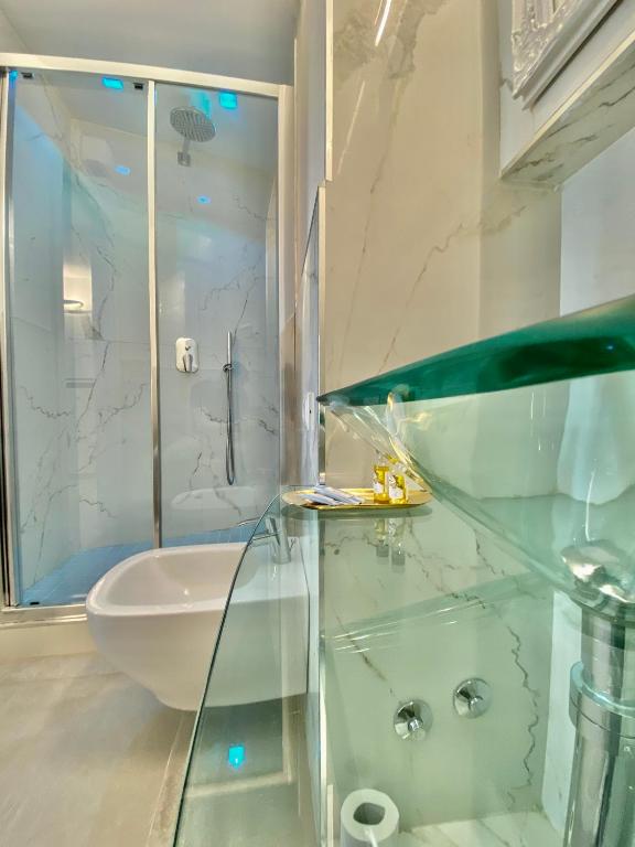 a bathroom with a glass shower and a sink at The Manarola Main Plaza in Manarola