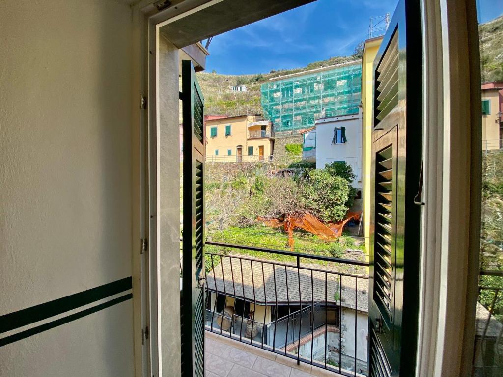 an open window with a view of a building at The Manarola Main Plaza in Manarola