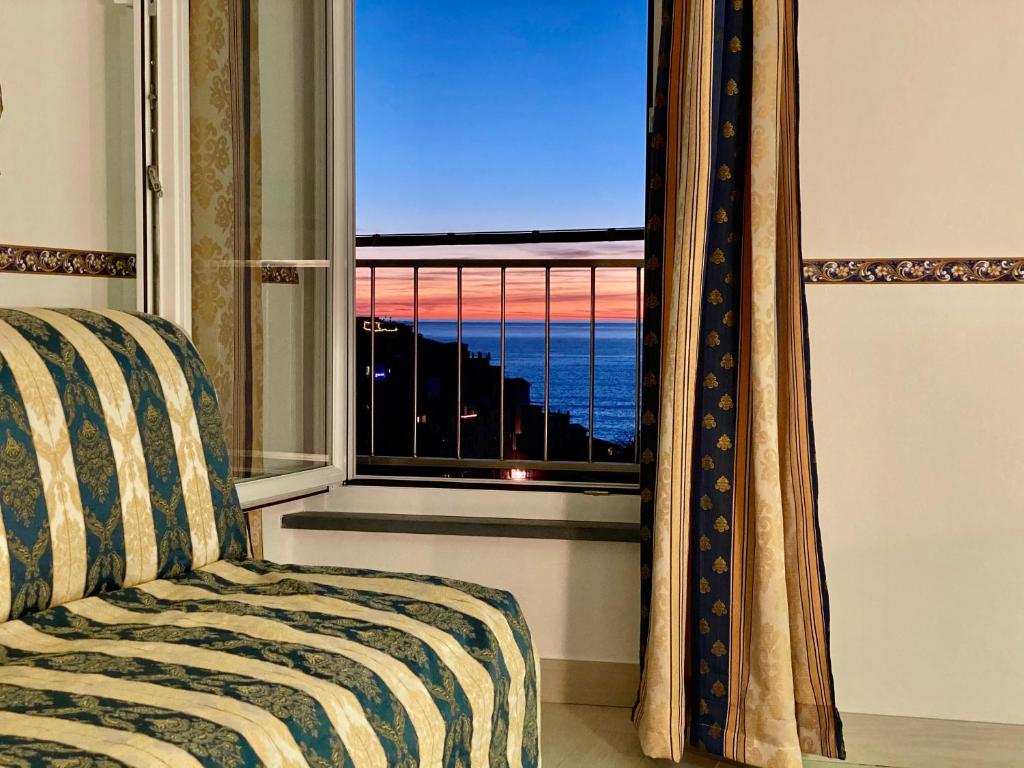 a bedroom with a window with a bed and a view at The Manarola Main Plaza in Manarola