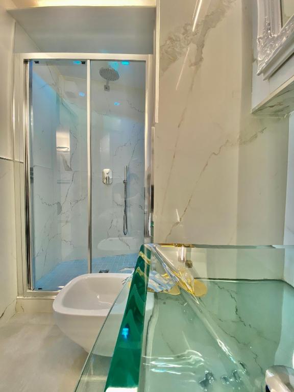 a bathroom with a glass shower and a sink at The Manarola Main Plaza in Manarola