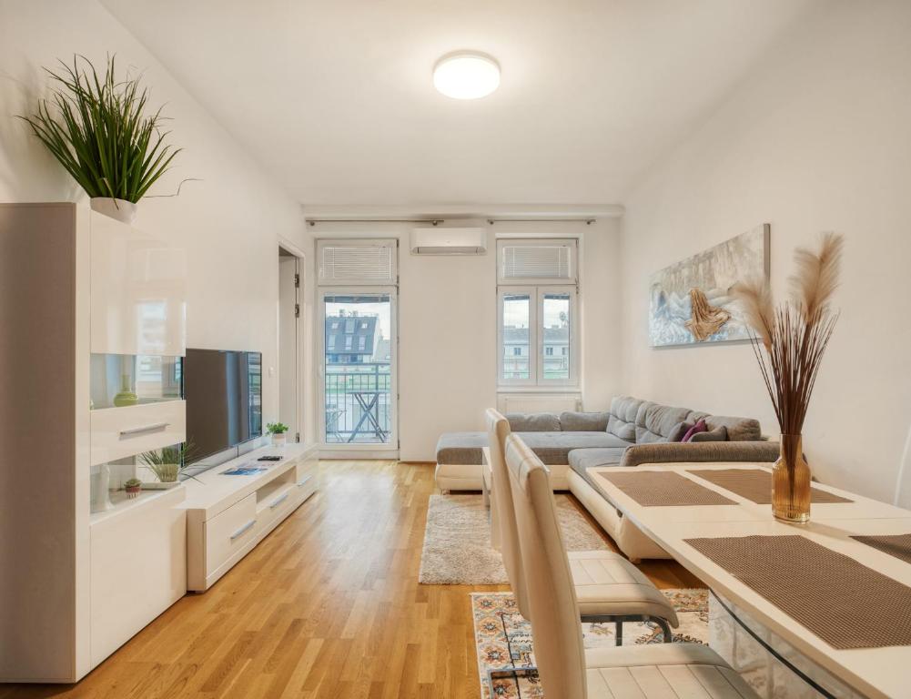 a living room with a couch and a table at Flarent Vienna Apartments-HG in Vienna