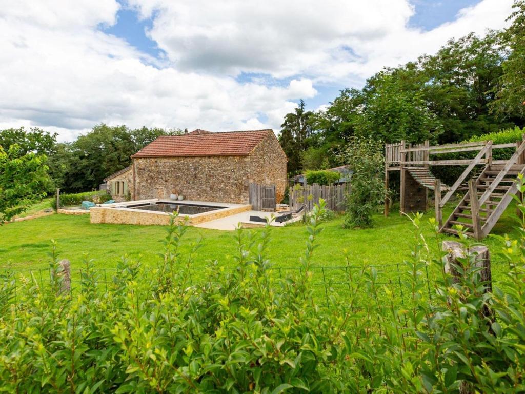 a stone house with a pool in a yard at Rustic holiday home in Loubejac with jacuzzi in Loubejac