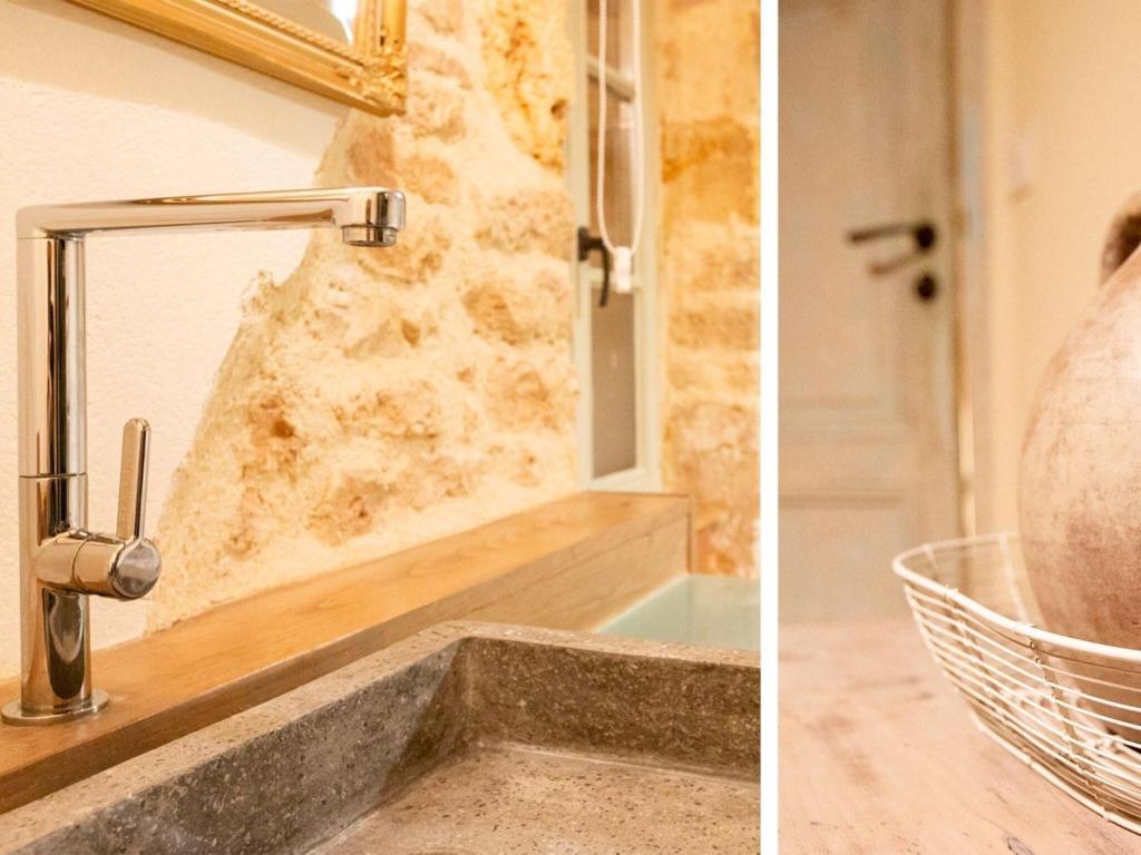 a bathroom sink with a faucet and a mirror at Rustic holiday home in Loubejac with jacuzzi in Loubejac