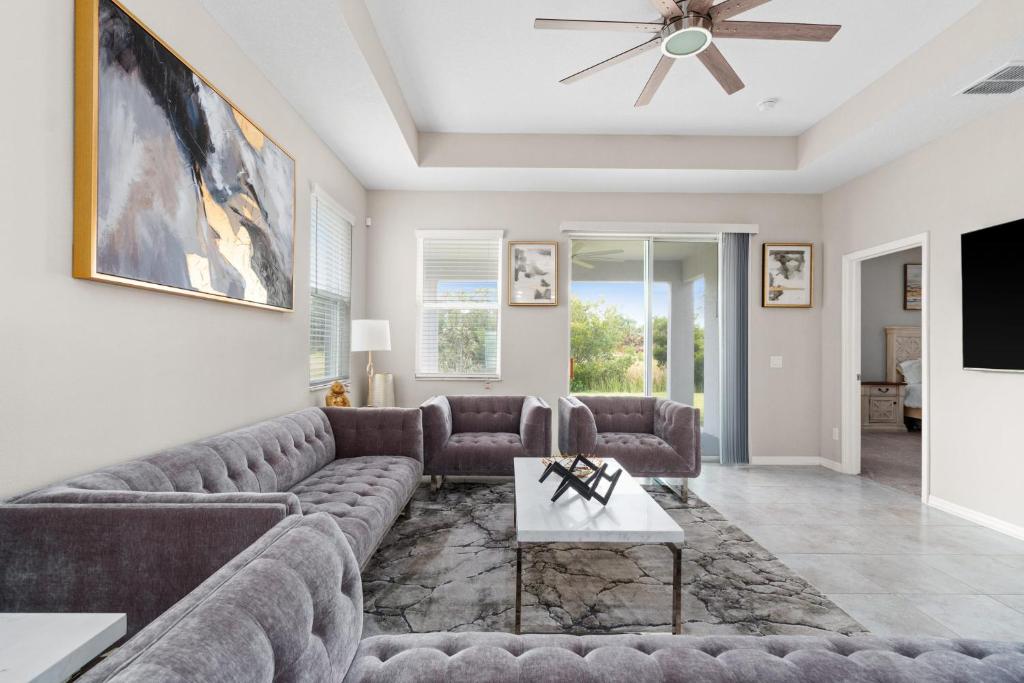 a living room with a couch and a tv at Luxurious Tampa Bay Area Home in Serene Community! in Riverview