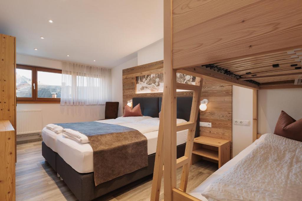 a bedroom with two bunk beds in a room at Alpenvilla Winklwiese in Valdaora