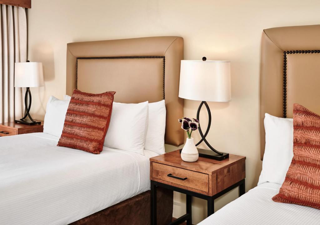 a hotel room with two beds and two lamps at The Inn at Aspen in Aspen
