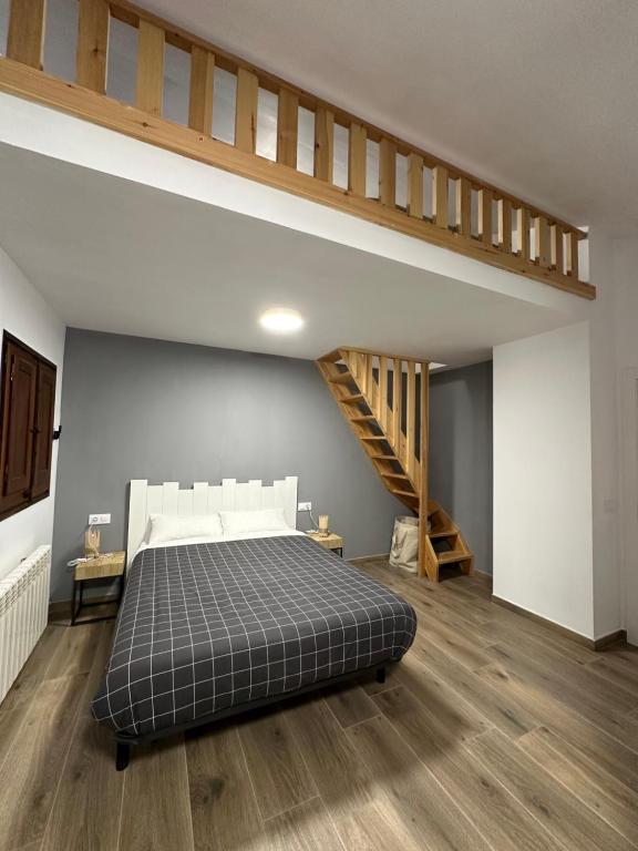 a bedroom with a bed and a staircase at Coll de Port in Tuixen