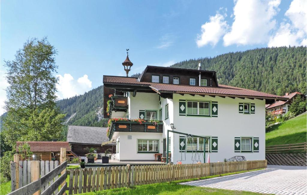 a large white house with a wooden fence at Gorgeous Apartment In Schladming With Kitchen in Schladming