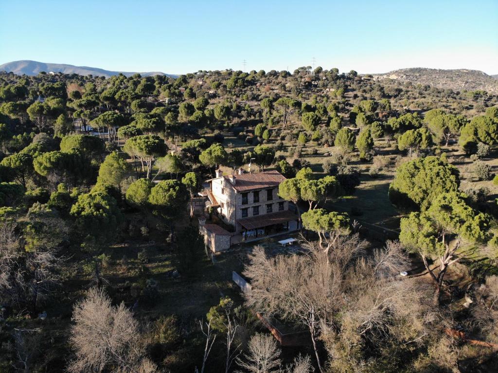 an old house in the middle of a forest at Casa Valdesanmartin - Country House, 10500sqm, Pool, Paddel & Bbq in El Tiemblo