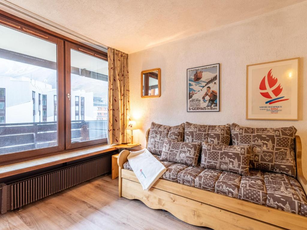 a living room with a couch and a window at Apartment Le Prariond-4 in Tignes