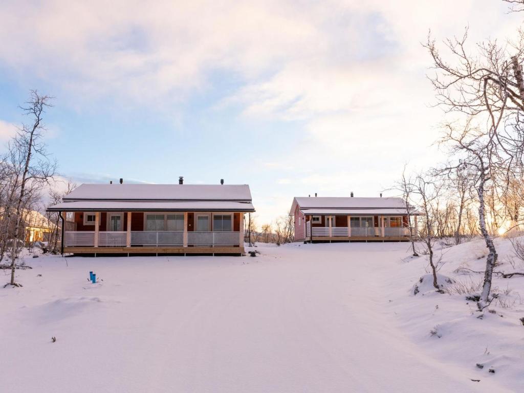 two houses in the snow with snow covered ground at Holiday Home Saana 4 by Interhome in Kilpisjärvi