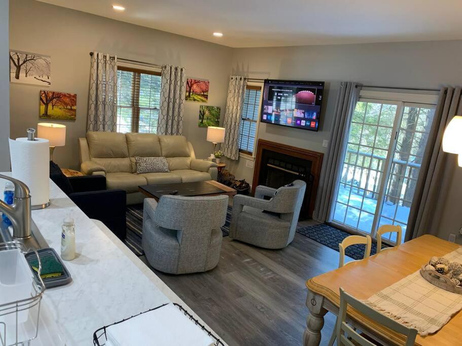 a living room with a couch and a fireplace at Jiminy Peak Mountainside Getaway in the Berkshires in Hancock