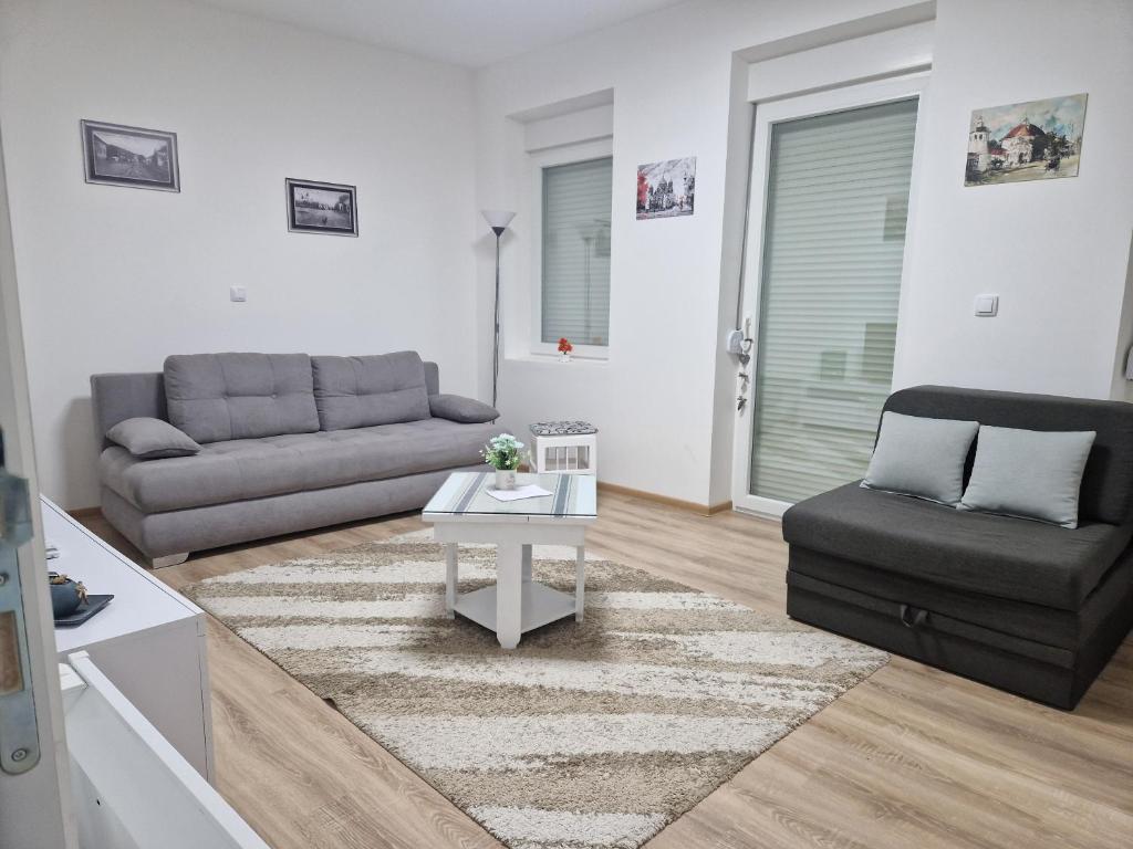 a living room with a couch and a table at Apartman Mihajlovic Brus in Brus