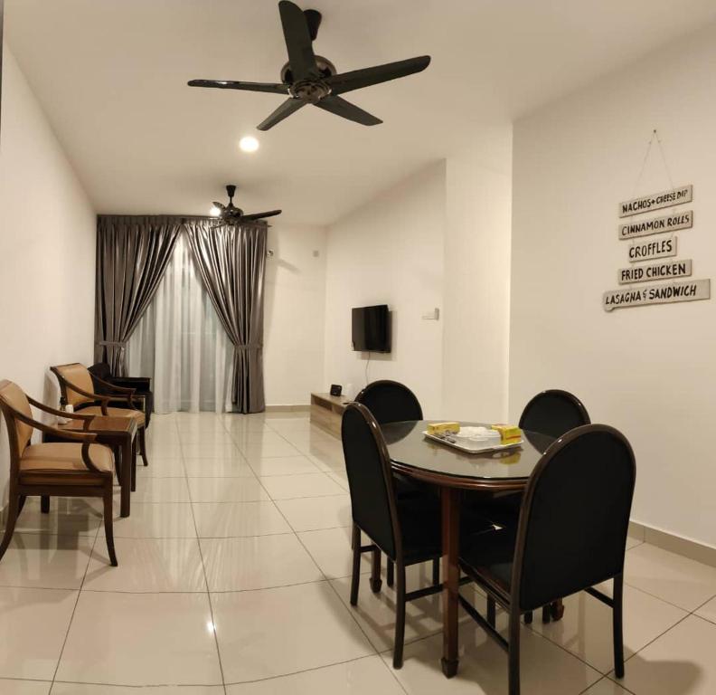 a dining room with a table and chairs and a ceiling fan at MFA Putrajaya Homestay in Putrajaya