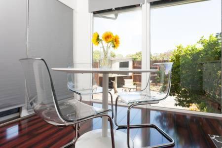 a glass table and two chairs in front of a window at Modern studio near UCSF/Chase/Oracle Park in San Francisco