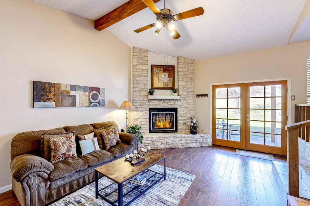 a living room with a couch and a fireplace at La Vie in Lago Vista in Lago Vista