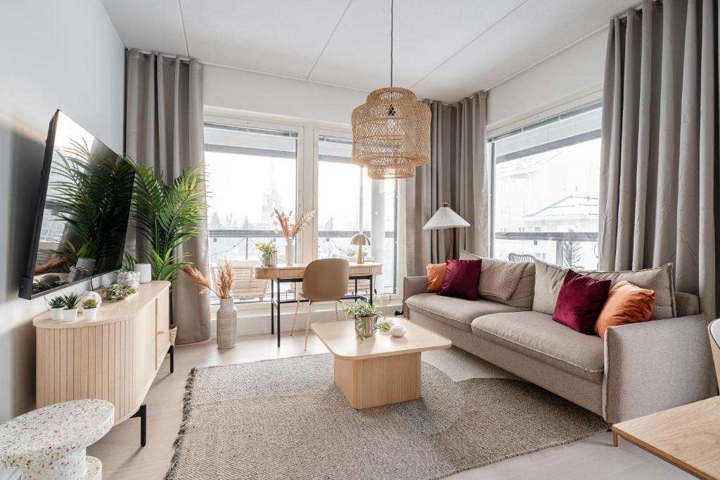 sala de estar con sofá y mesa en 2ndhomes Tampere "Sonetti" Apartment - Modern 2BR Apartment with Sauna and Balcony, en Tampere
