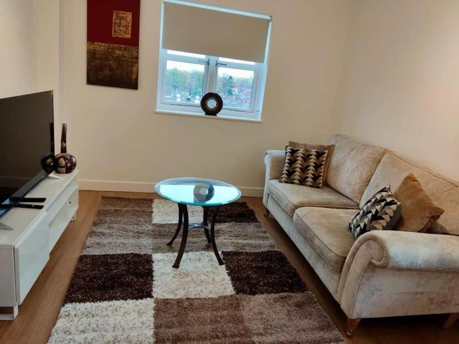 a living room with a couch and a table at Relax in this cosy scenic Crib in Leicester