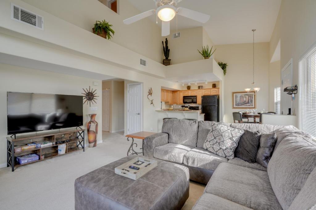 a living room with a couch and a table at Mesquite Condo with Pool and Spa Access, Near Casinos! in Mesquite