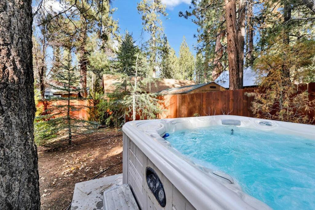 a hot tub in the middle of a forest at Bear Paw Cottage~ Hot Tub~ Resort Base Camp Cottage~ in Big Bear Lake