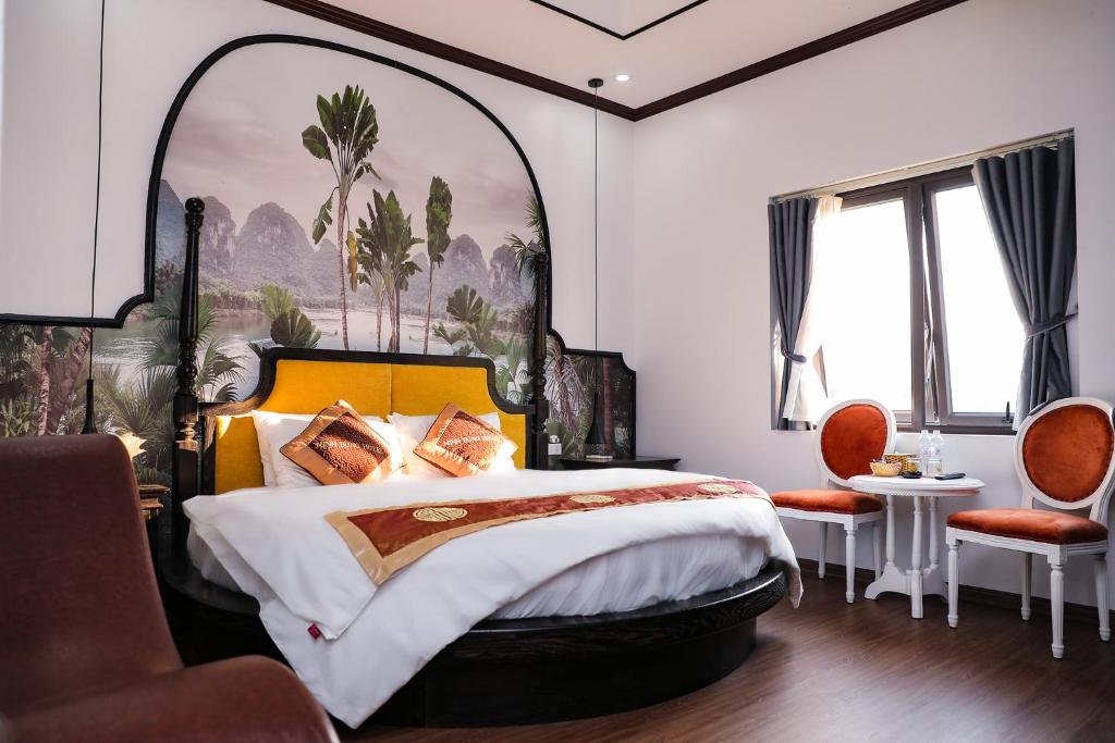 a bedroom with a large bed with a large painting on the wall at Minh Dung Hotel in Lao Cai