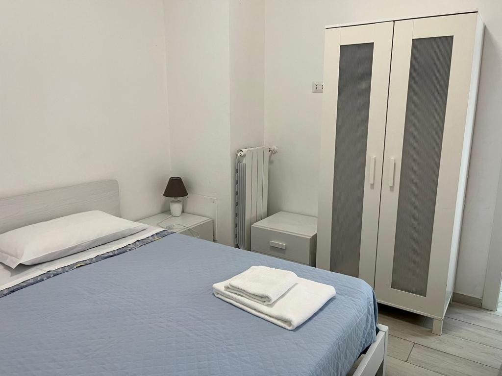 a bedroom with a bed with two towels on it at Apartment Orio Volta in Orio al Serio