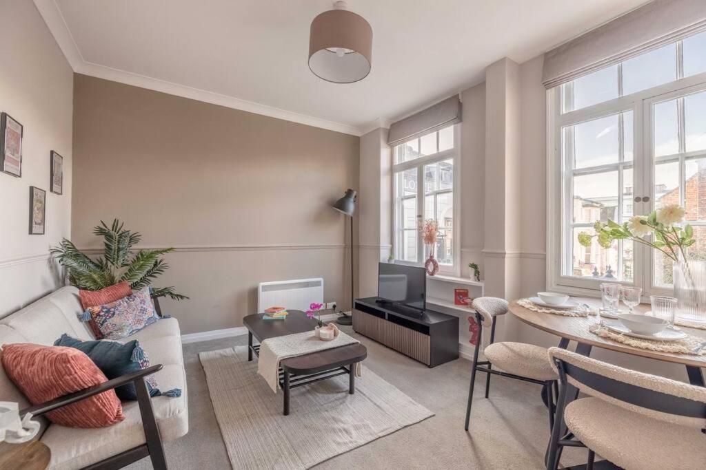 a living room with a couch and a table at Windsor Castle Chic: 1BR,Parking in Windsor