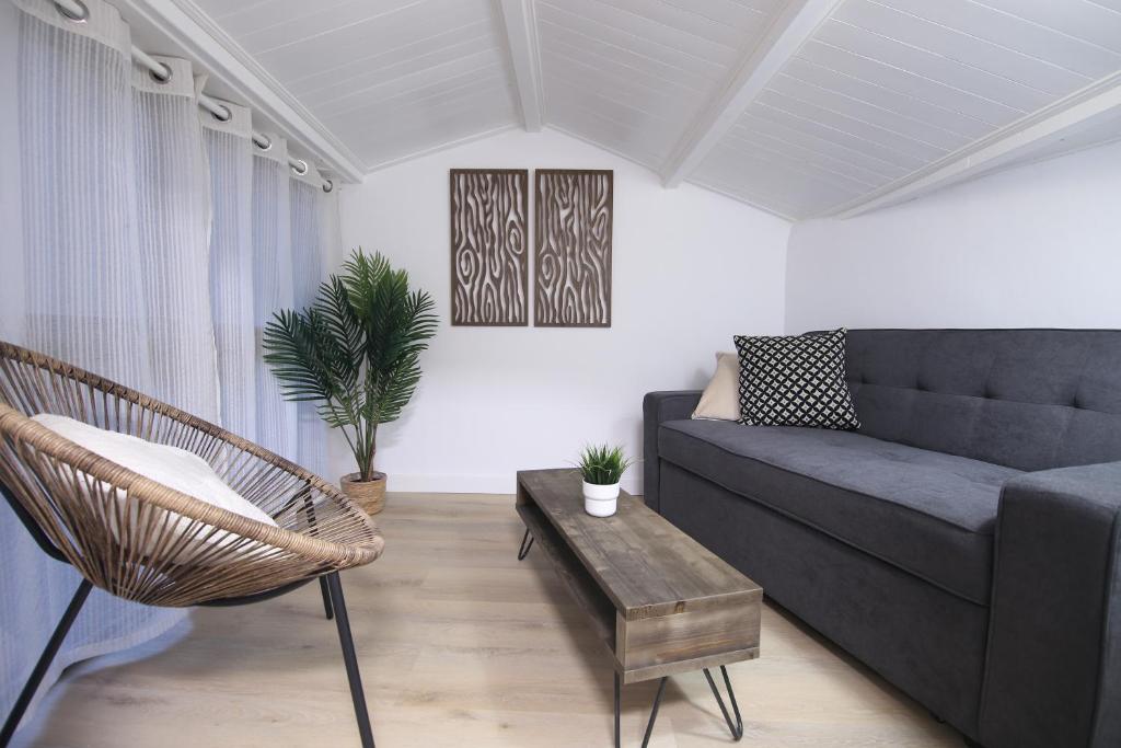 a living room with a couch and a table at Zurriola beach brand new apartment by Cisan Rentals in San Sebastián