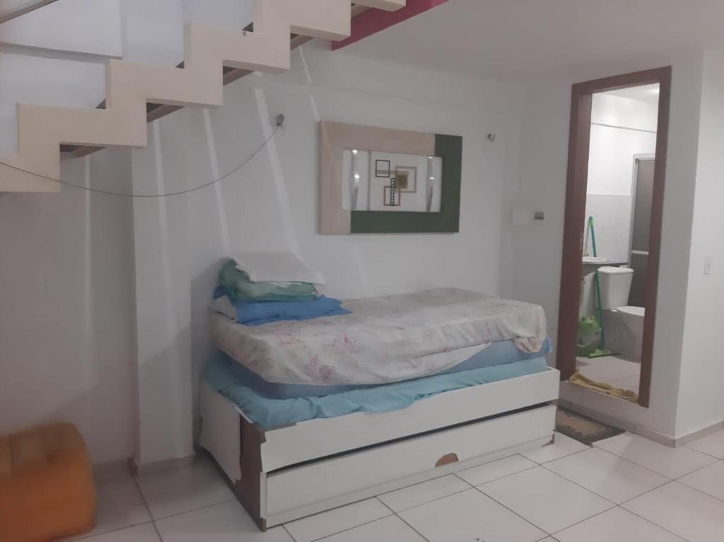 a bedroom with a bunk bed and a mirror at Flat Amarração 130 in Luis Correia