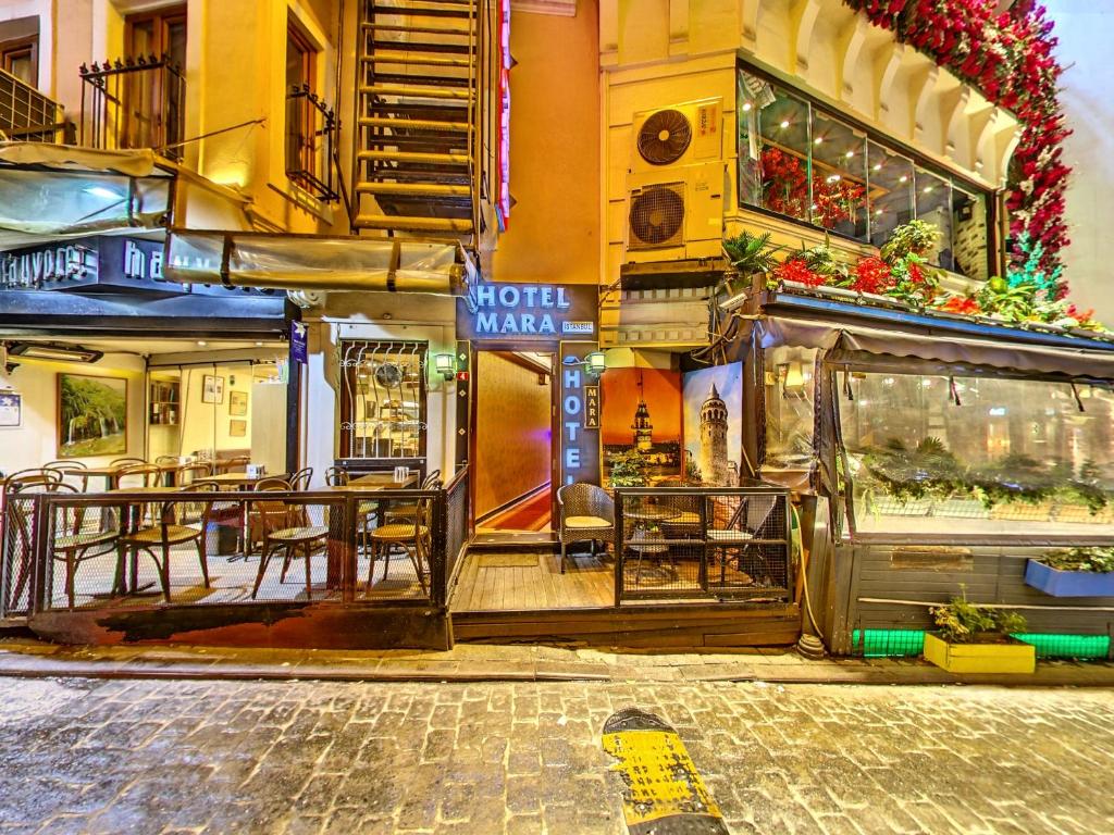 a restaurant with tables and chairs in front of a building at Hotel Mara İstanbul in Istanbul