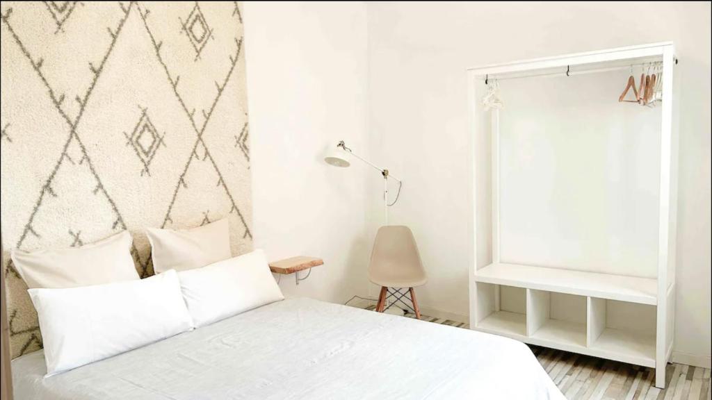a bedroom with a white bed and a window at Nordic Apartment II Sagrada Familia in Barcelona