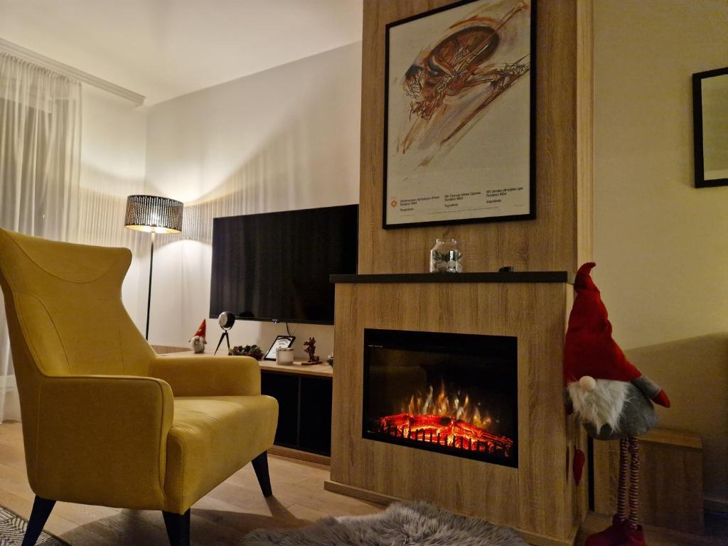 a living room with a santa hat next to a fireplace at Olimpijska kuca 202 in Jahorina