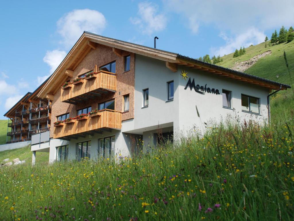 a building on the side of a hill at Haus Montana in Damuls