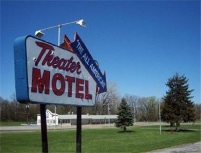 a sign for a theater motel in a field at Theater Motel in Westfield