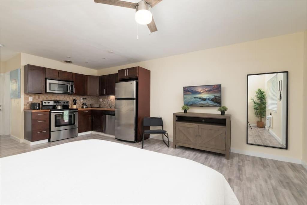 a large kitchen with a bed and a ceiling fan at Just Off Wilton Drive Apt 6 in Fort Lauderdale