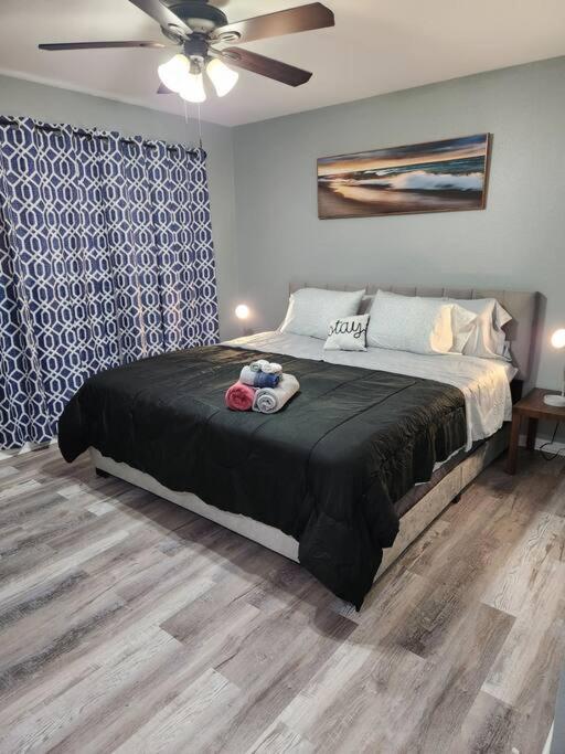 a bedroom with a large bed with a ceiling fan at Blue Shark *B2* @ Bellaire 1BR King Apartment Near Medical Center in Houston