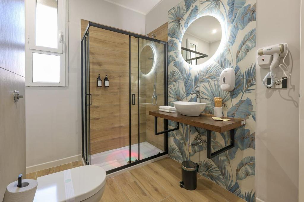 a bathroom with a shower and a toilet and a sink at Cuore Napoli Centro in Naples