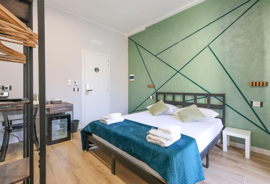 a bedroom with a bed with a green wall at Cuore Napoli Centro in Naples