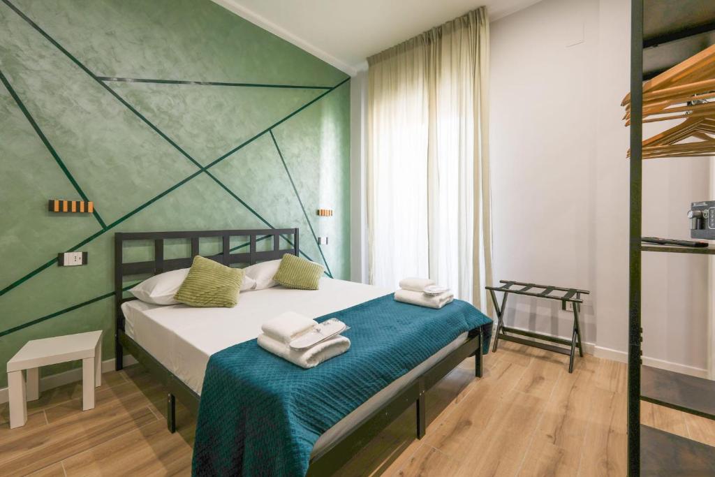 a bedroom with a bed with towels on it at Cuore Napoli Centro in Naples