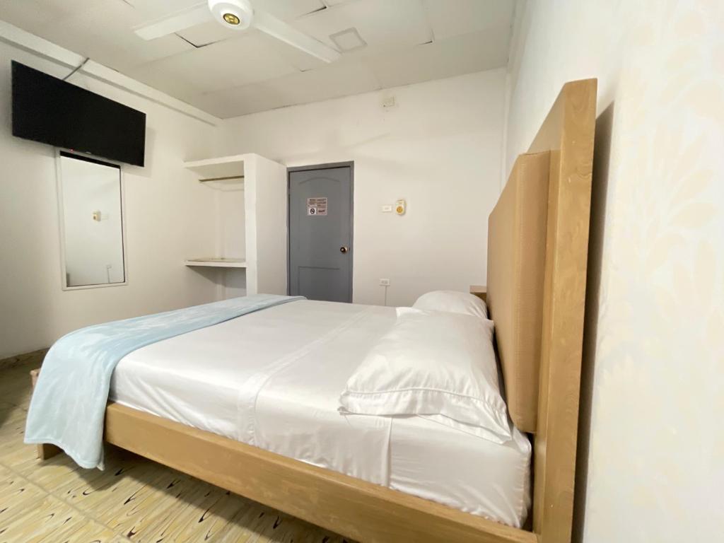 Postel nebo postele na pokoji v ubytování Hotel Balcon de Oro Curumani