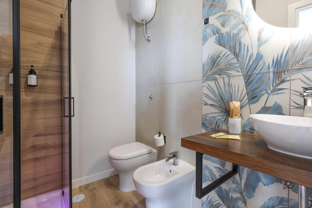 a bathroom with a toilet and a sink at Cuore Napoli Centro in Naples