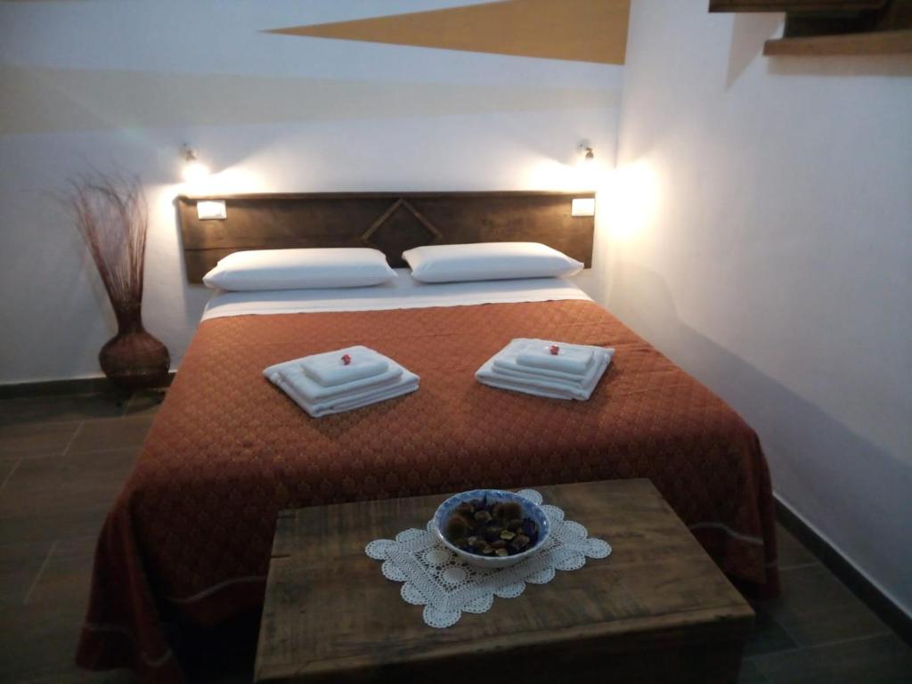 a bedroom with a bed with a bowl of food on it at Bed And Breakfasts LA CASETTA in Terranova di Pollino