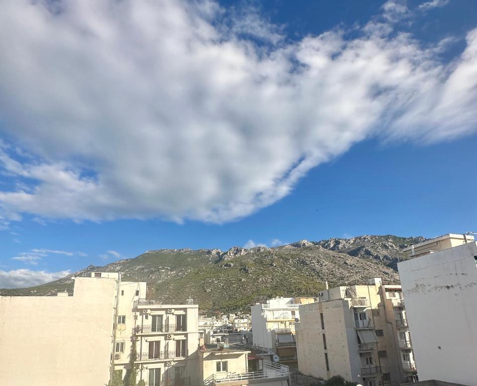 a group of buildings with a mountain in the background at Eleni’s Mountainview Central Studio by the Sea in Loutraki