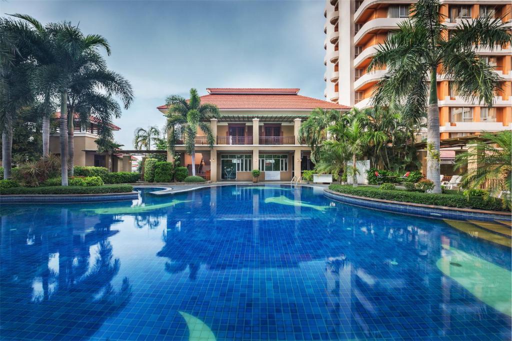 een groot blauw zwembad voor een gebouw bij Eastern Grand Palace in Pattaya South
