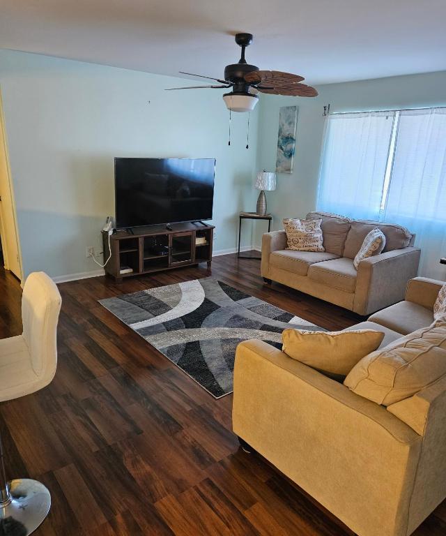 a living room with two couches and a flat screen tv at Nice 2 Bedroom 1 Bath Condo Across From Broadway in Myrtle Beach