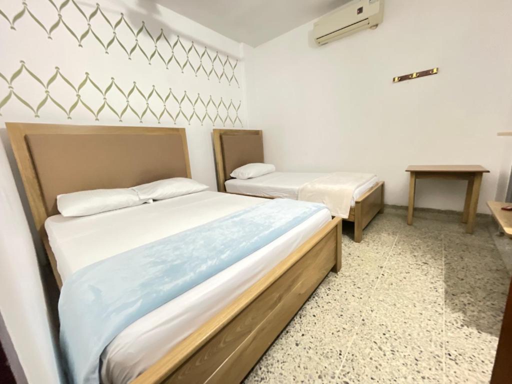 Postel nebo postele na pokoji v ubytování Hotel Balcon de Oro Curumani