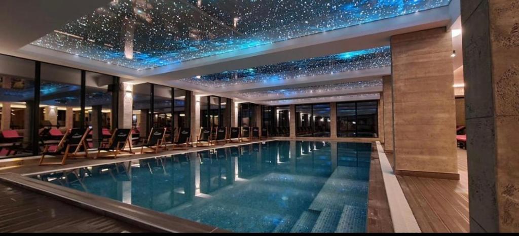 a swimming pool in a building with stars on the ceiling at ICE-KOP Milmari in Kopaonik