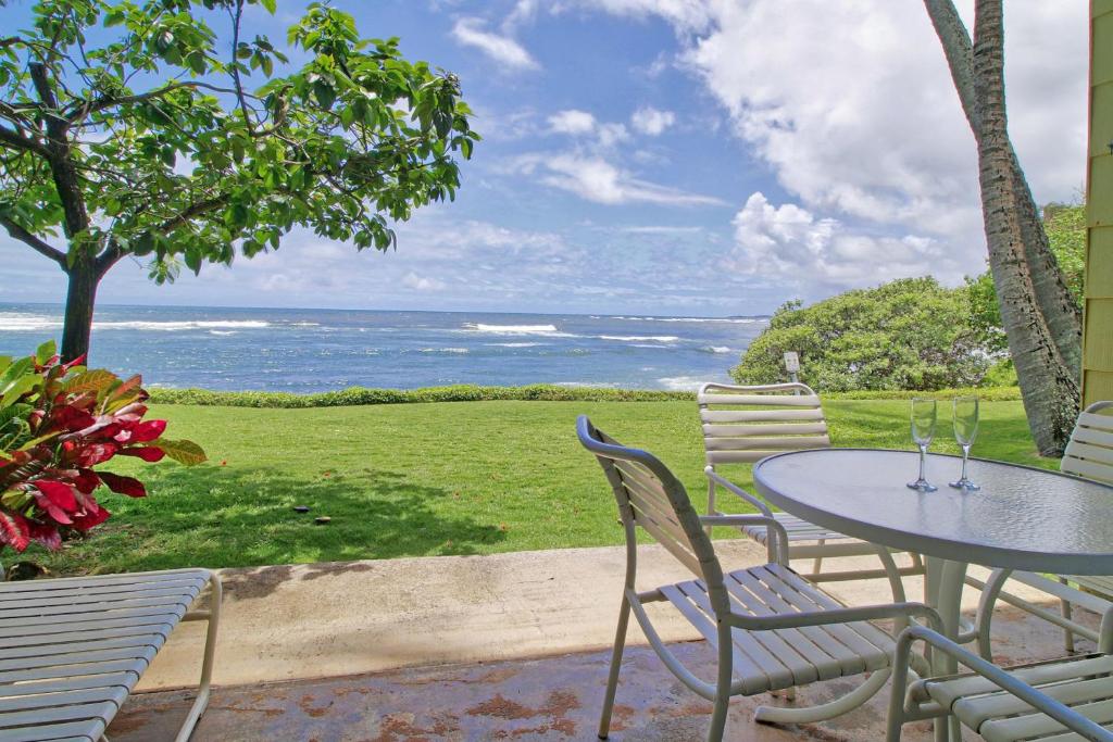 a table and chairs with a view of the ocean at Kapa'a Sands 08 in Kapaa