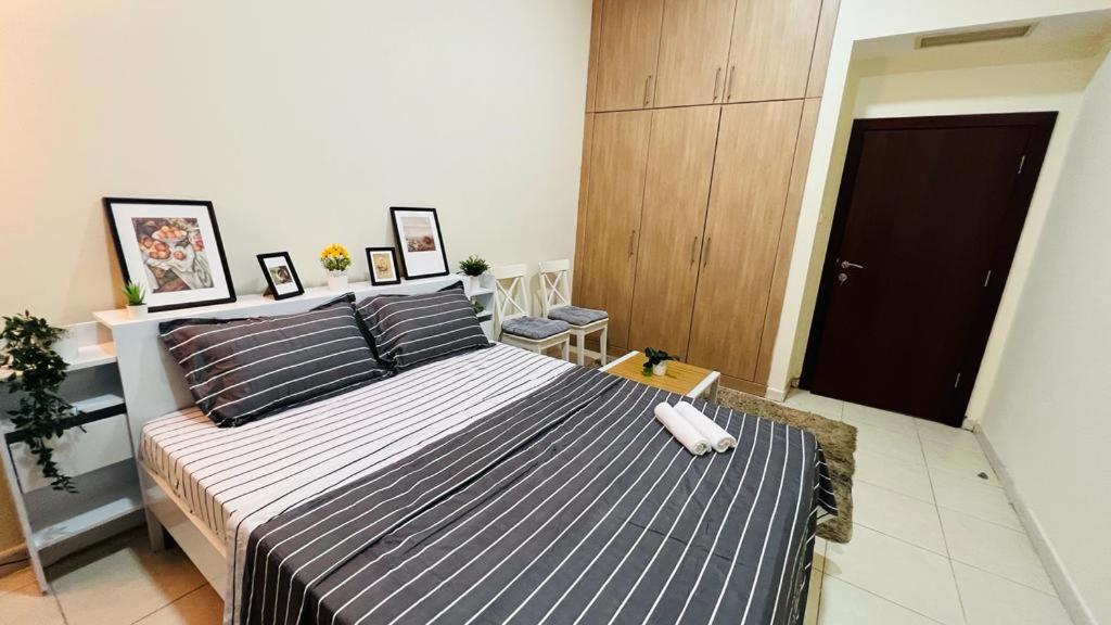 a bedroom with a large blue and white bed at Beautiful Bedroom in Al Barsha Near Mashreq Metro in Dubai