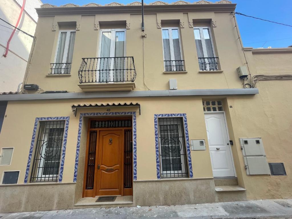 a yellow house with two doors and windows at Maison Sereine in Valencia